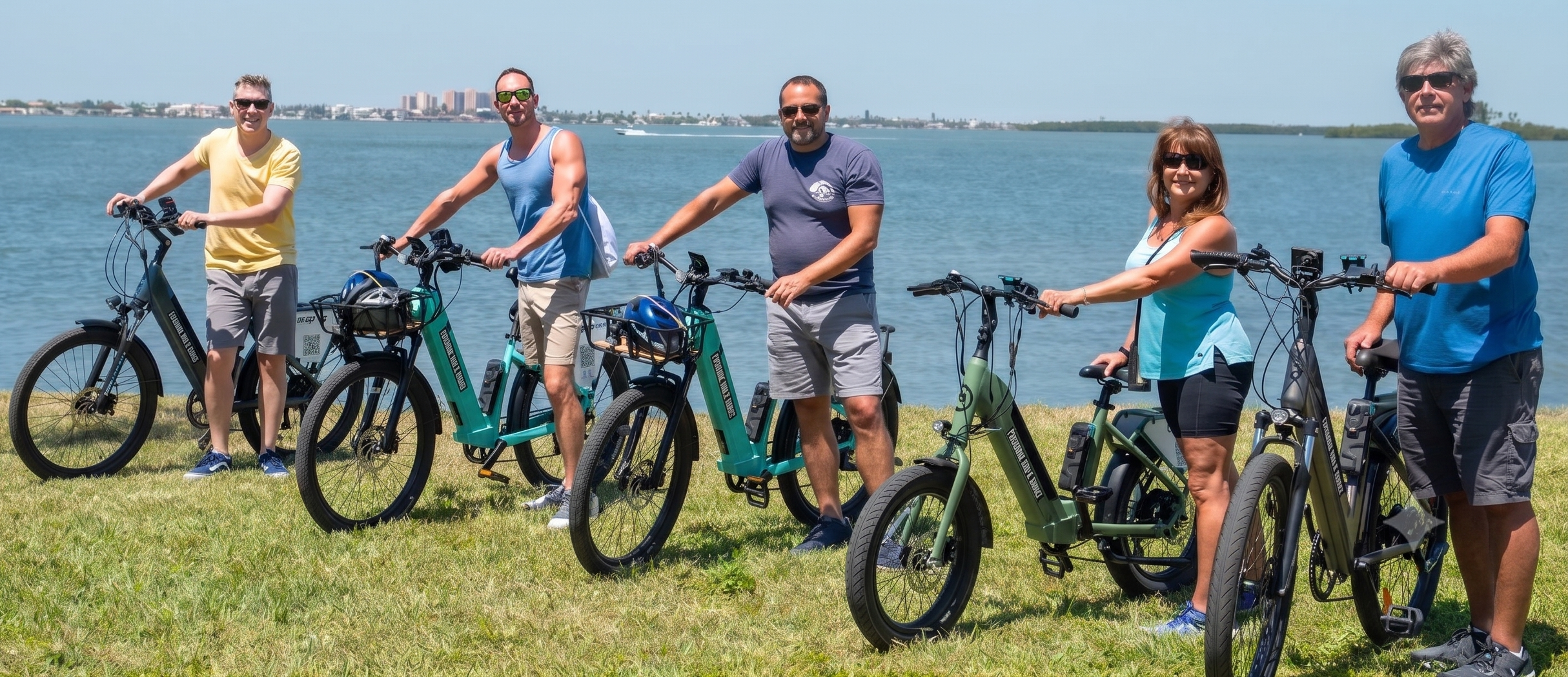 A group of six people enjoying a coastal electric bike tour with Paradise Life E-Bike Tours on a sunny day in Dunedin, Florida.