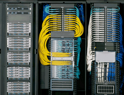 Three heavily cabled network racks