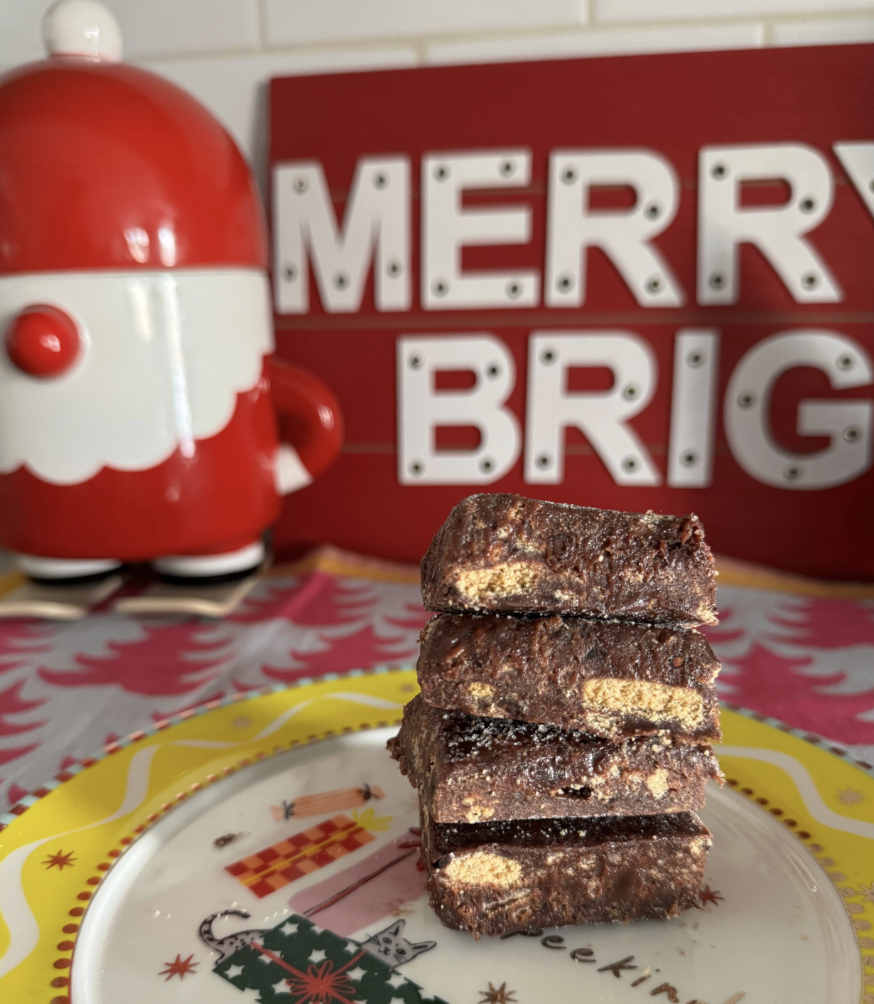 Close up of chocolate and condensed milk palha italiana cut into squares and stacked in a Christmas plate