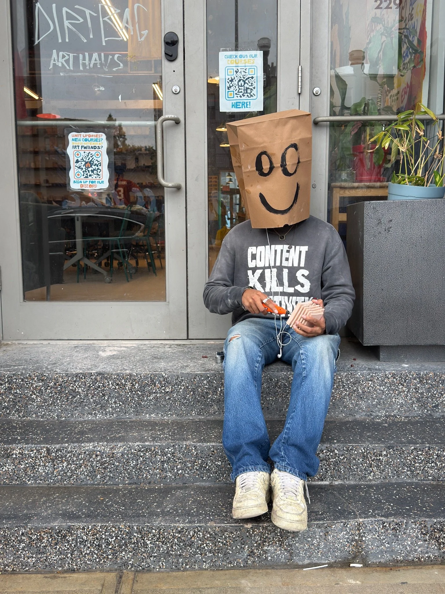 man on stoop wearing shirt that says "content kills"