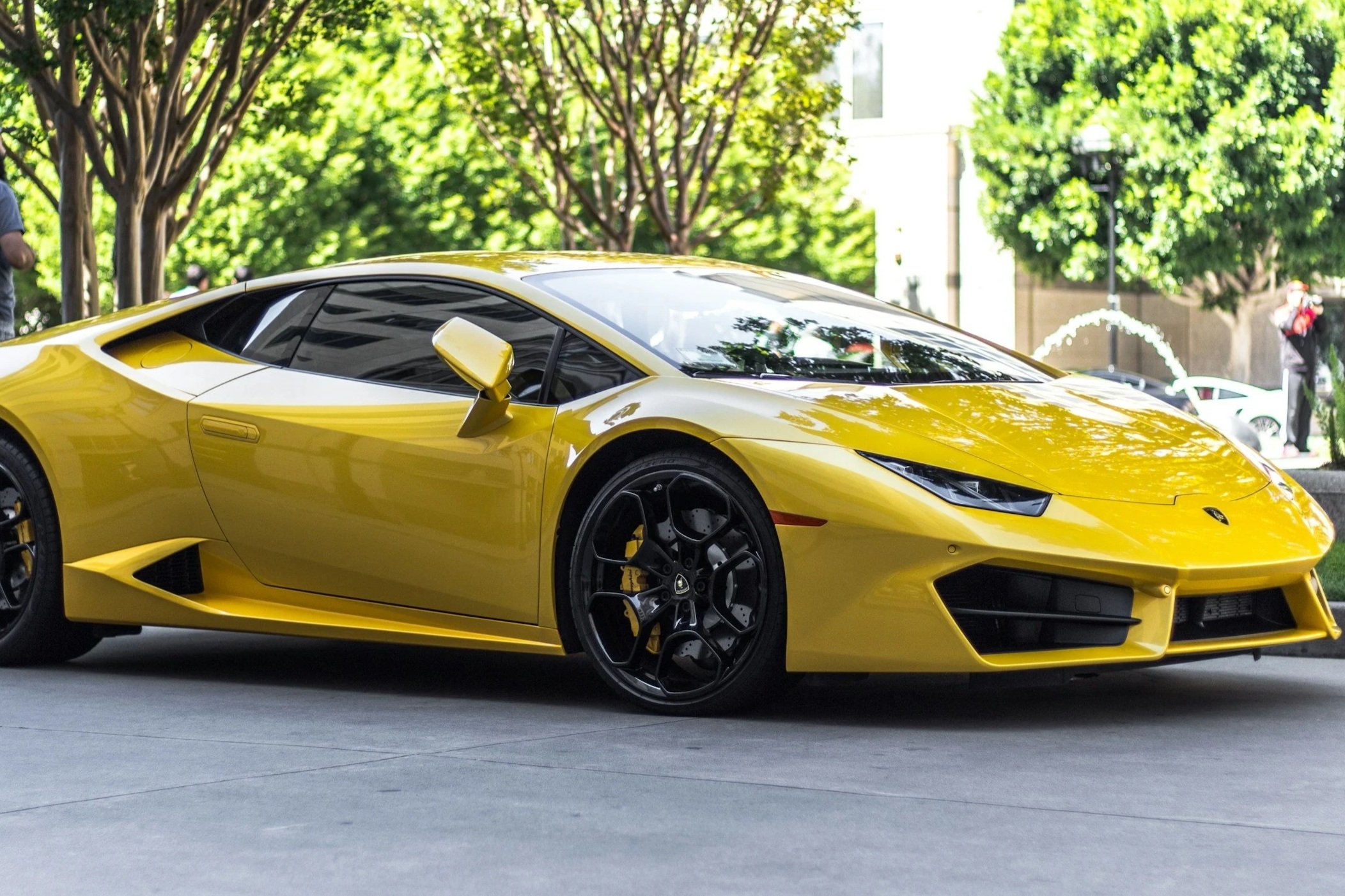 Gray pickup truck parked outdoors on a paved surface with trees in the background.