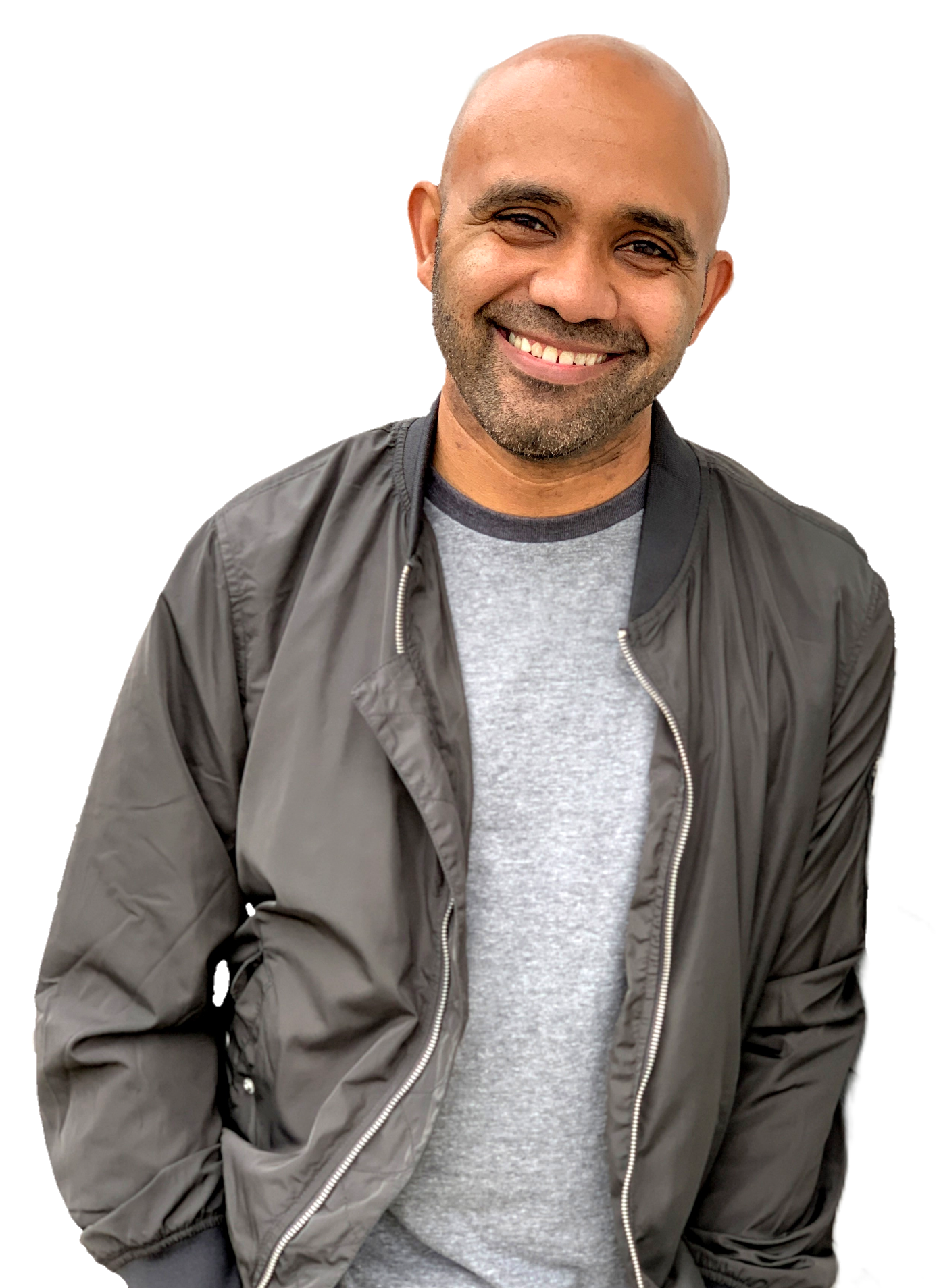 Smiling man with a beard, wearing a gray T-shirt and a black jacket, facing the camera.