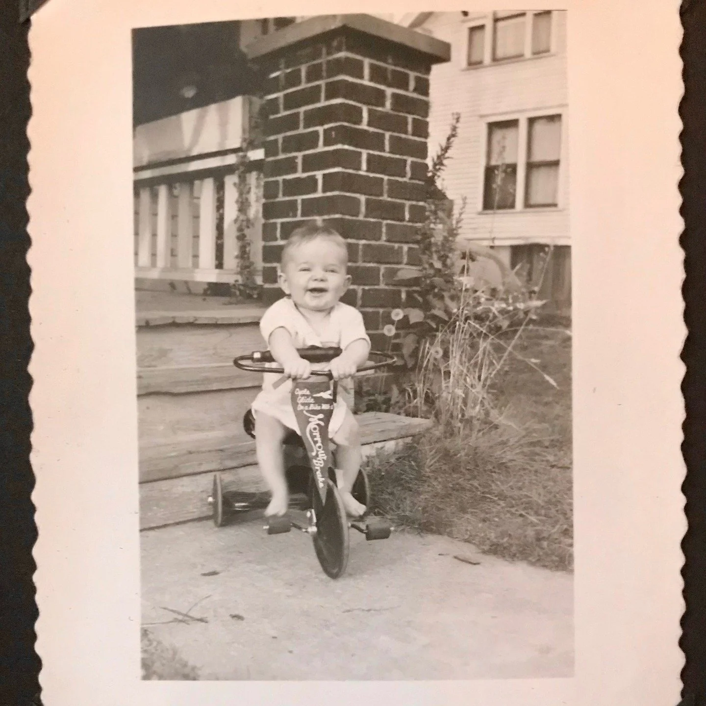 According to the caption, this was my dad at 6 months and 29 days. I'm not sure how he was on a tricycle so young, but he was an accomplished athlete in high school and college and awarded most inspirational several times over, so it is quite possibl