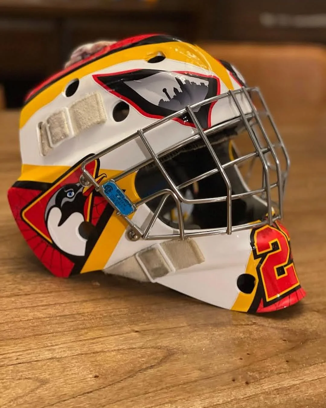 red and yellow custom goalie mask decal kit by Shutout Designs - spider web and penguins