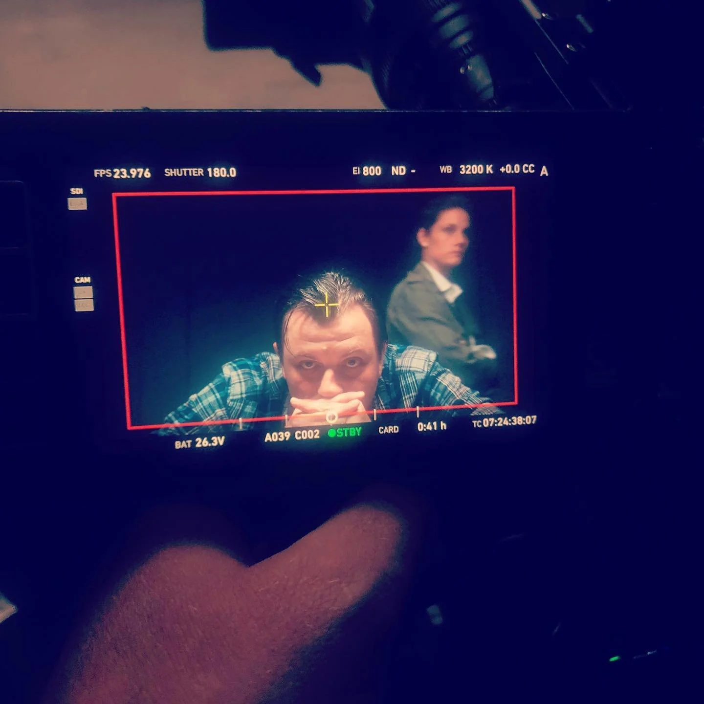 Behind-the-scenes view of Patrick Murney on a camera monitor during filming.