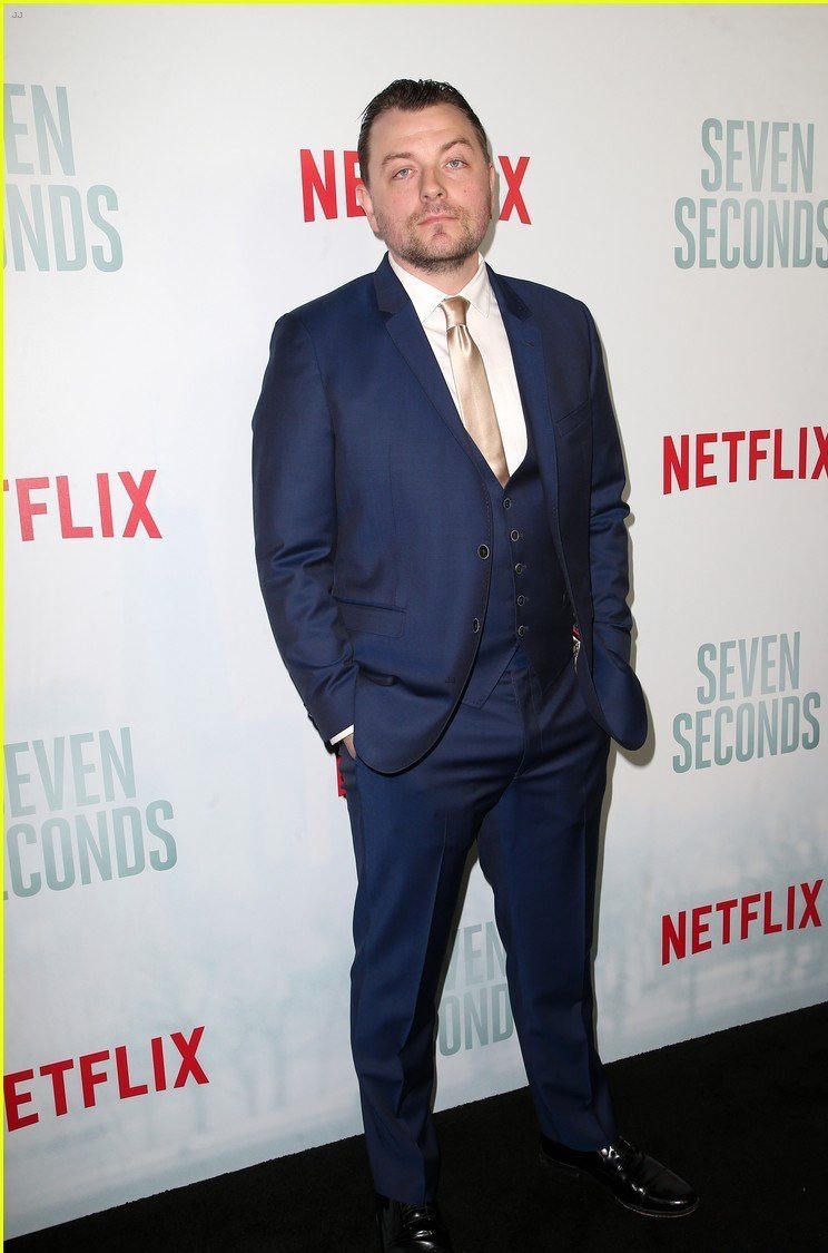 Patrick Murney posing for photographers at a premiere.