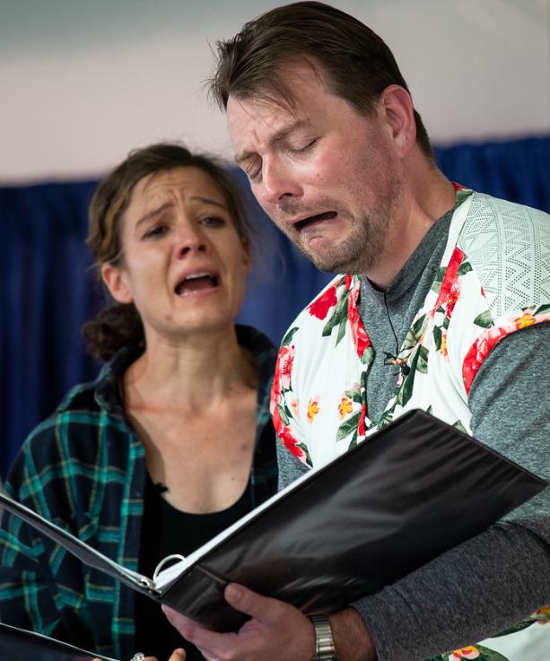 Patrick Murney performing on stage with a fellow actor during a dramatic scene.