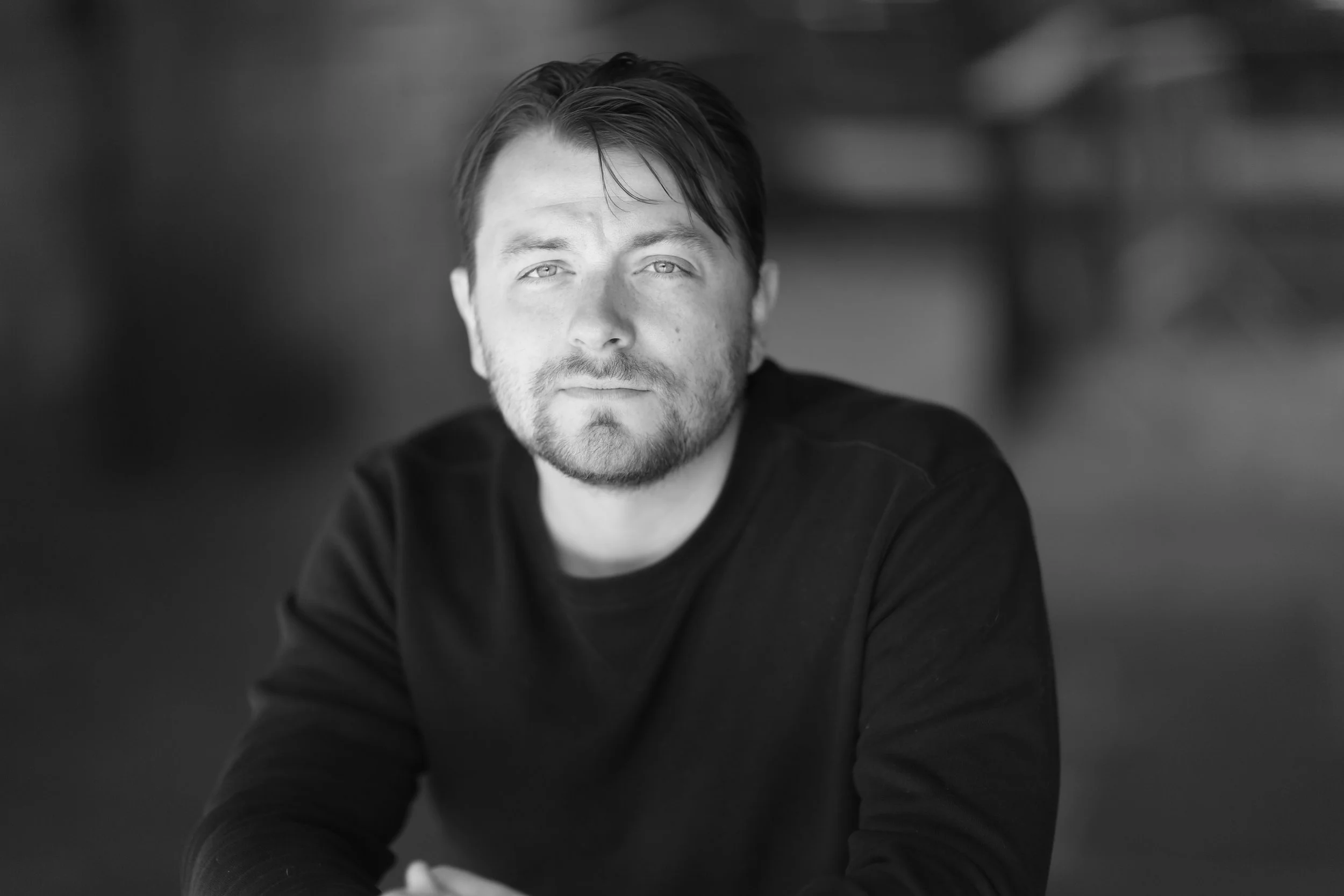 Patrick Murney professional black and white portrait against a soft background.
