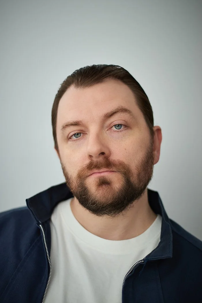 Patrick Murney close-up headshot with trimmed beard.