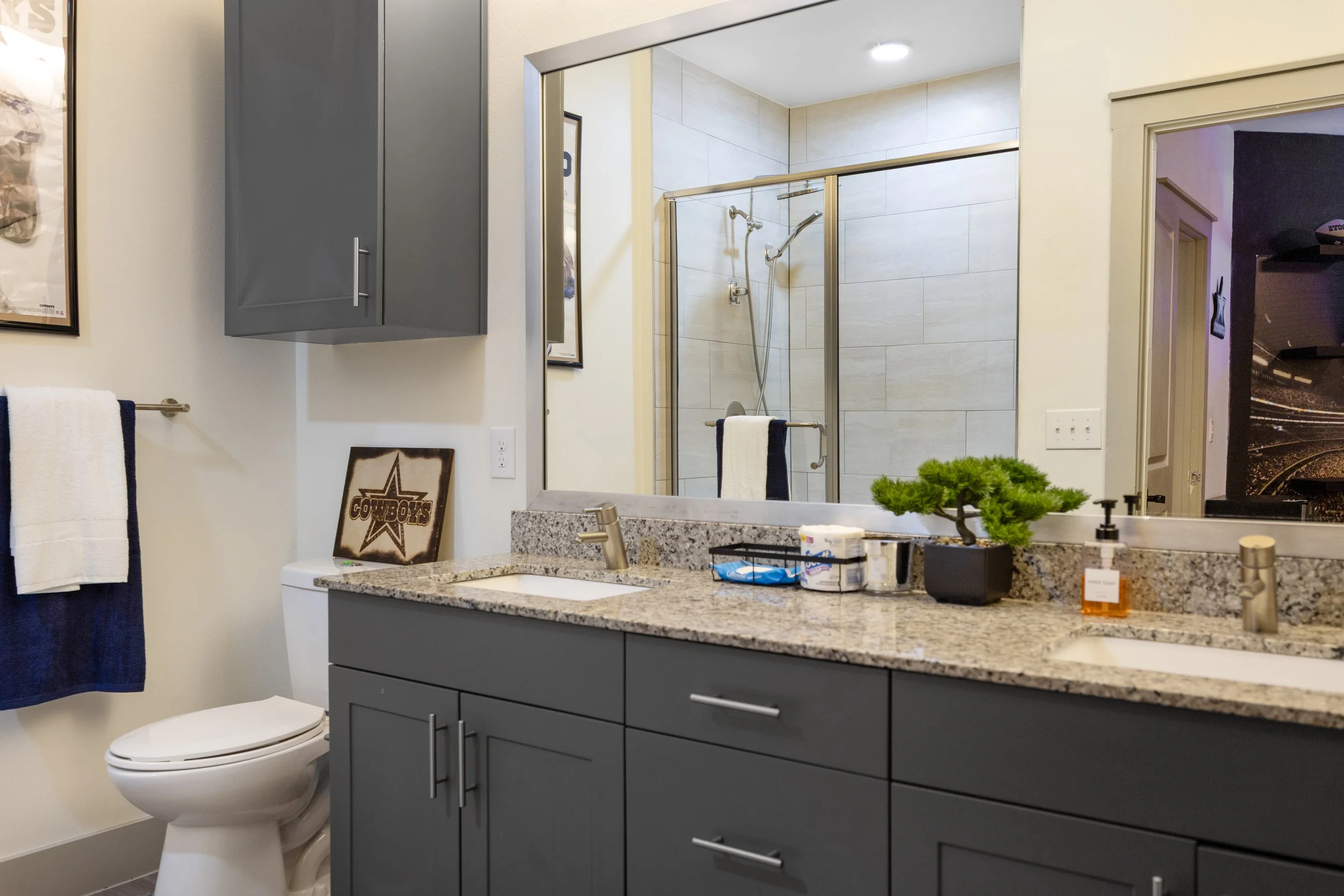 Airbnb and Vrbo bathroom with double vanity, granite countertop, and modern fixtures for guest convenience