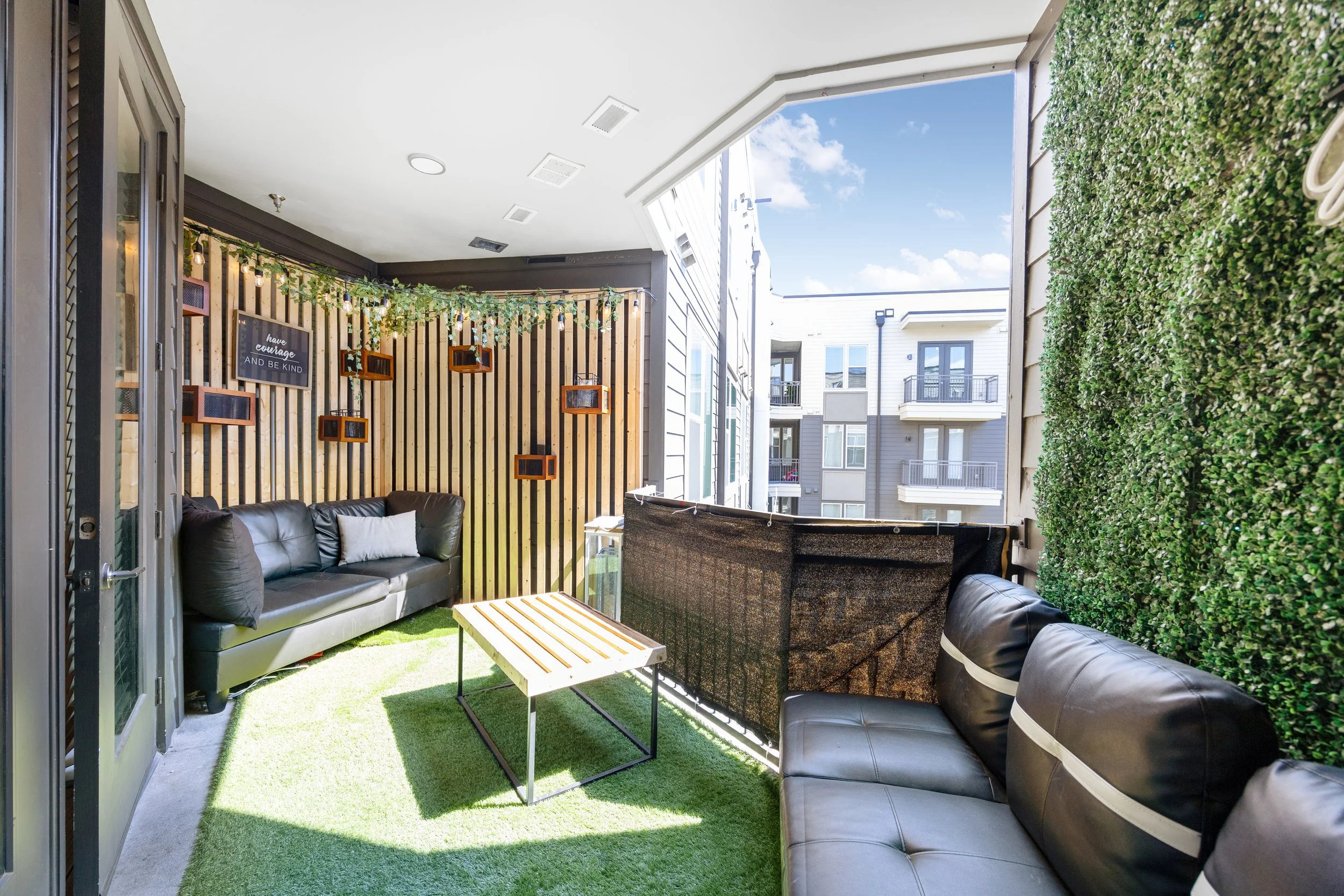 Airbnb and Vrbo balcony showcasing outdoor living space with seating and open residential views