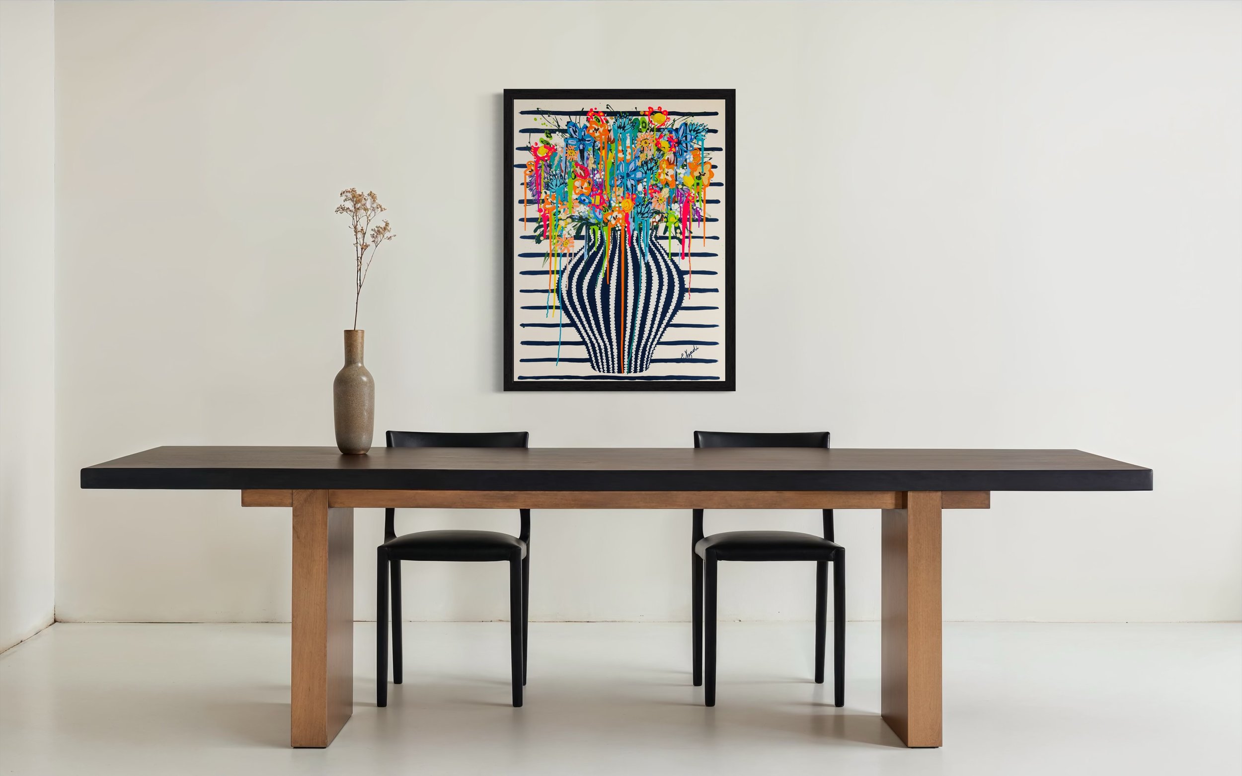 Large colorful floral abstract expressionism style painting by Elizabeth Azadi, with a navy blue and white striped vase and drippy flowers in a white dining room with modern furnishings