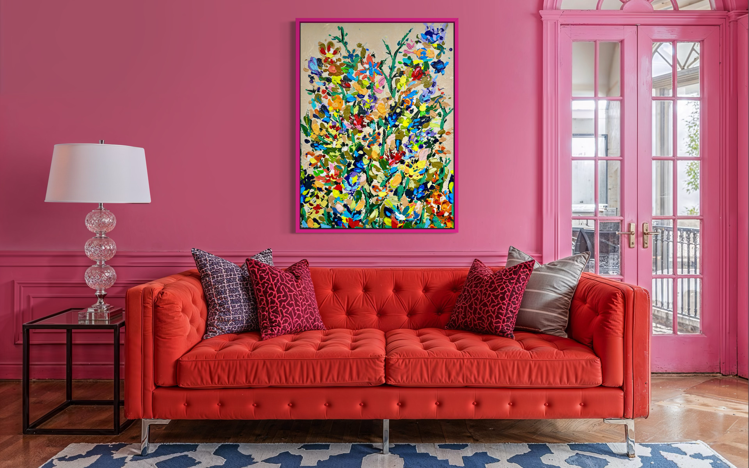 Large colorful floral abstract expressionism style painting with by Elizabeth Azadi, with a colorful wildflower arrangement in a pink living room with a red sofa