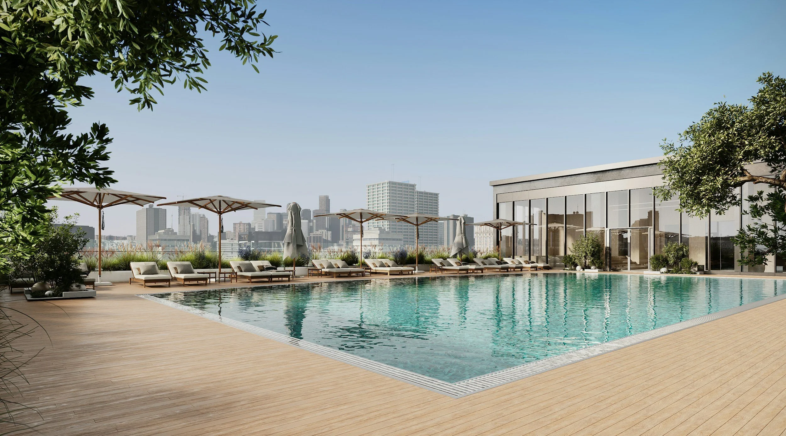 City skyline view from a rooftop pool area with loungers and umbrellas, surrounded by greenery.