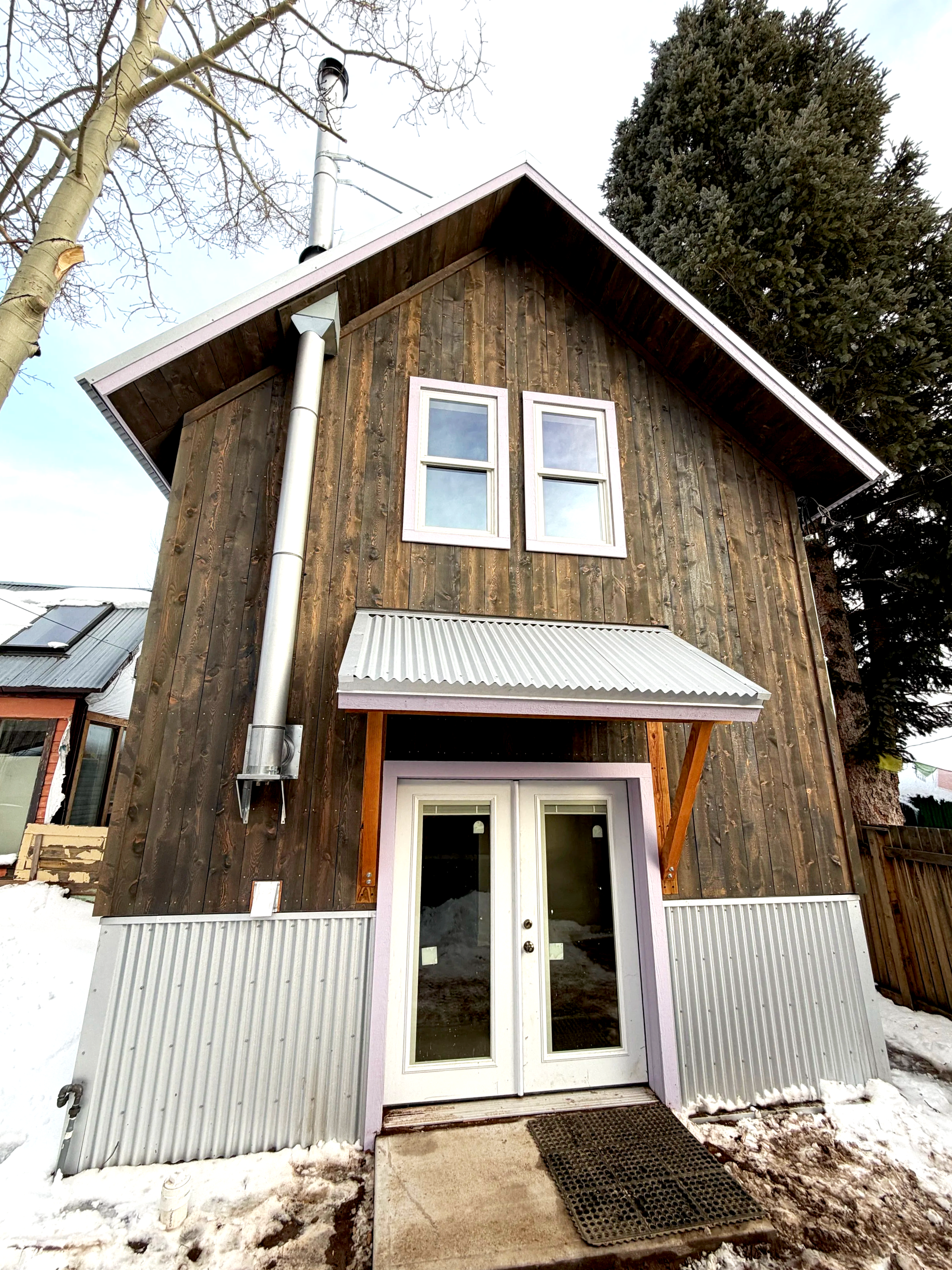 Finished Exterior - Stained wood siding with trim to match existing home features