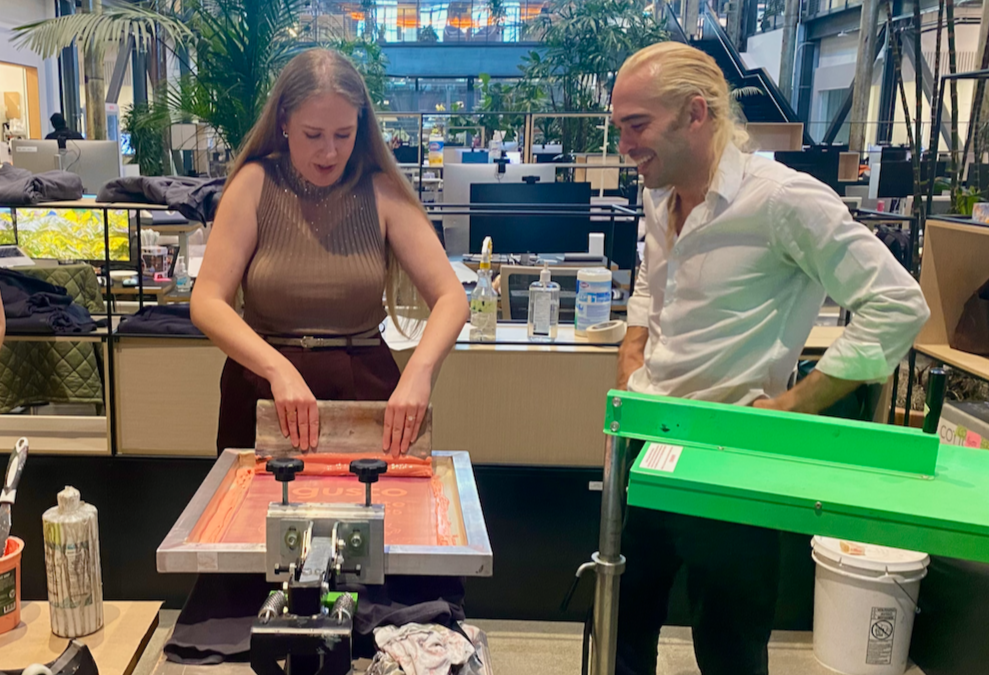 Woman holding a squeegee at a mobile printing press