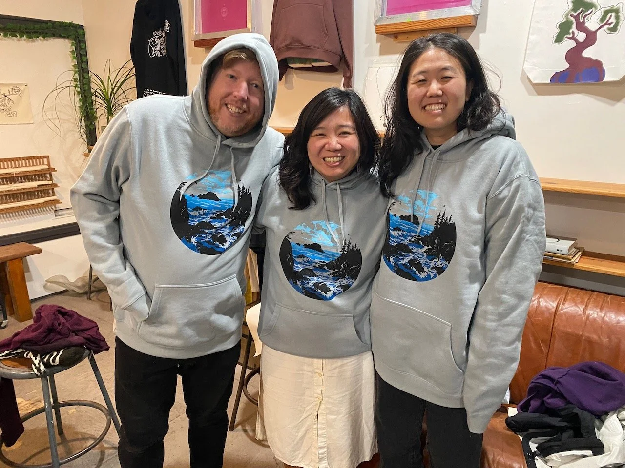 Man pulling a squeegee as another smiles and looks on