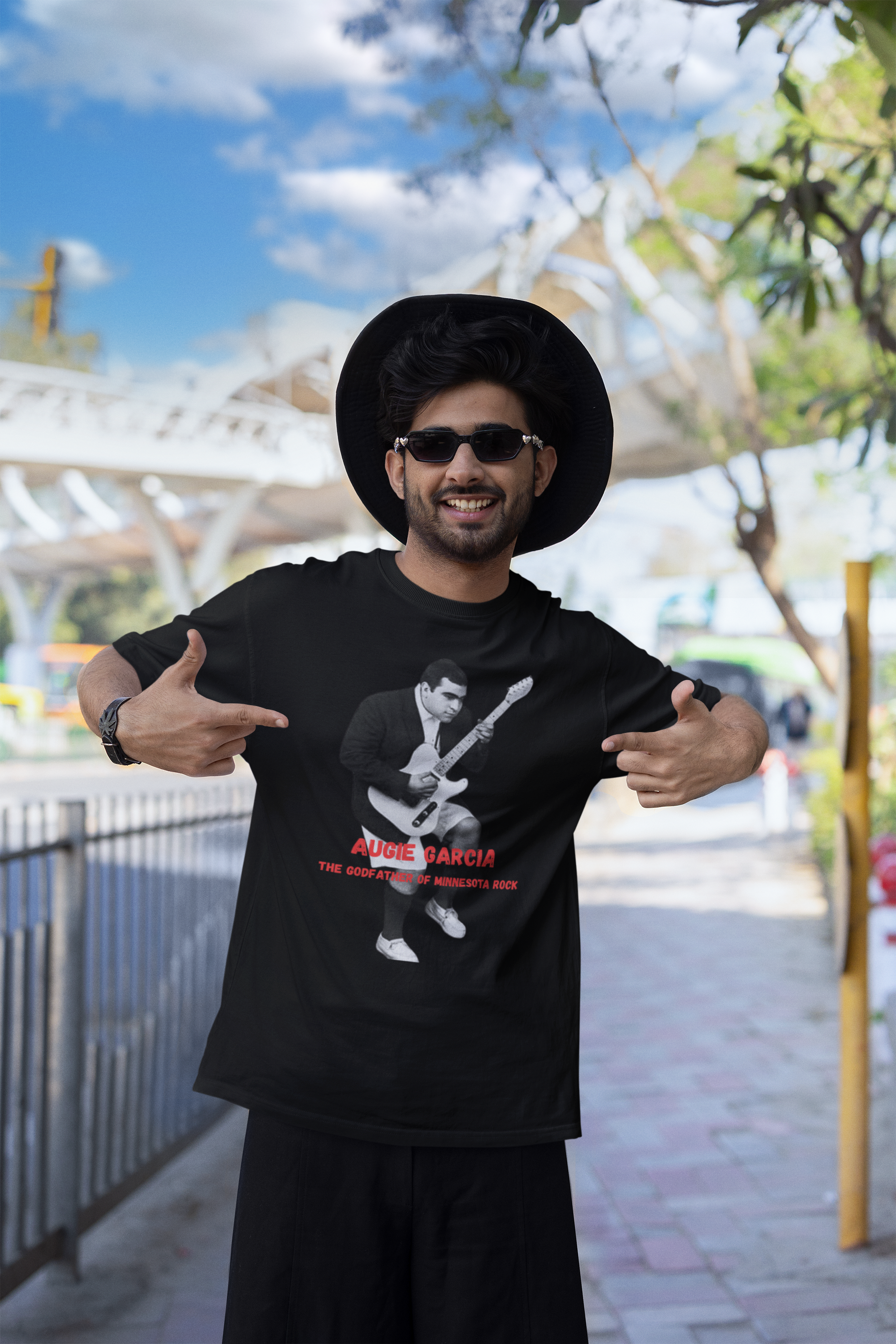 blinkstore-mockup-featuring-a-happy-man-pointing-at-his-t-shirt-in-the-street-m39062.png