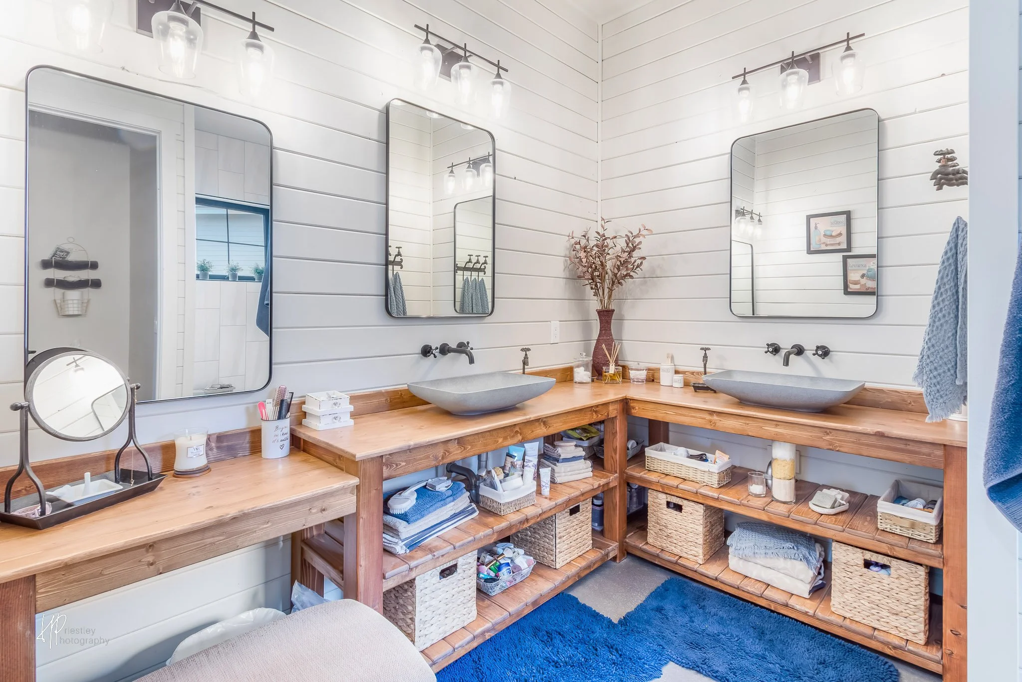 Master bathroom with concrete details, white walls, and classic mirrors