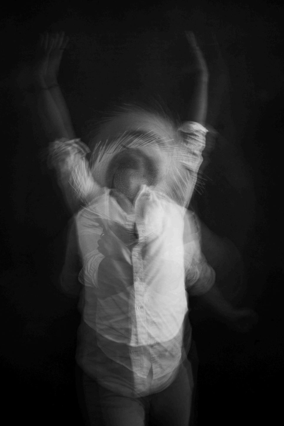 Black and White blurred image of person in straw hat