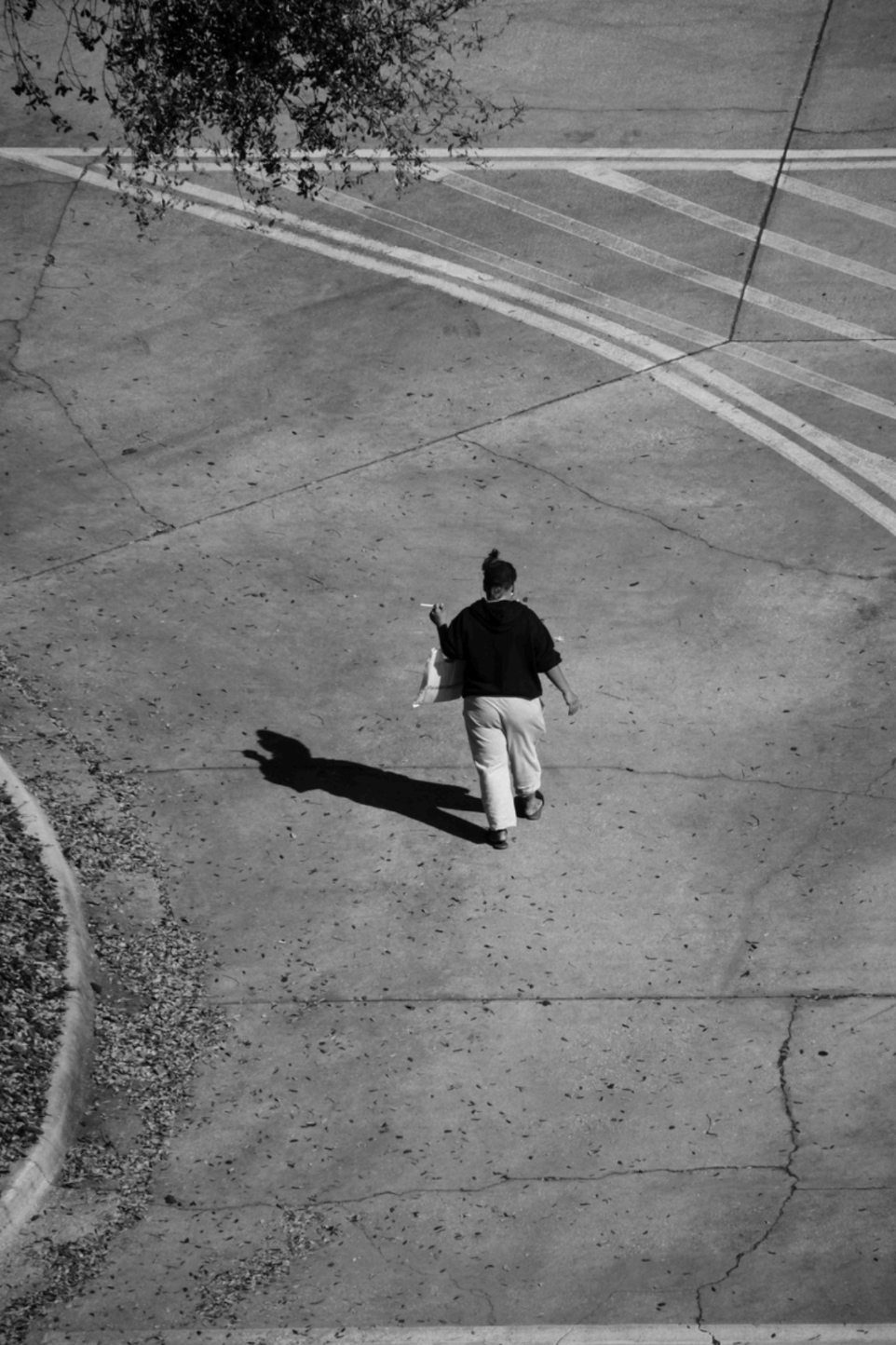 Black and White image of person walking on a street