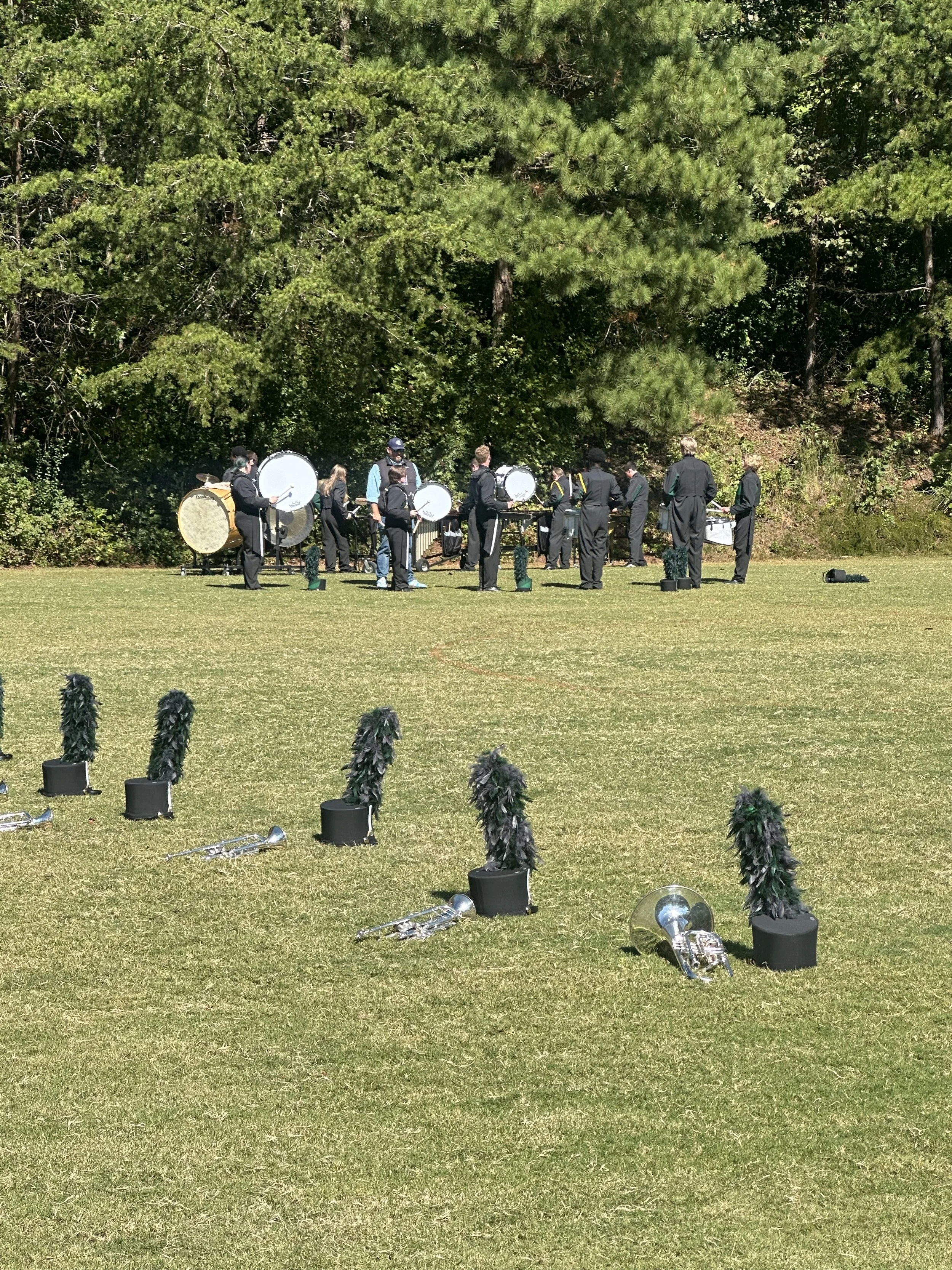 percussion warming up at a competition in a grassy field