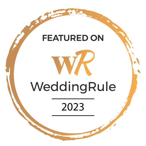 WeddingRule logo featuring 'Featured on WeddingRule 2023' with a gold and white circular badge.