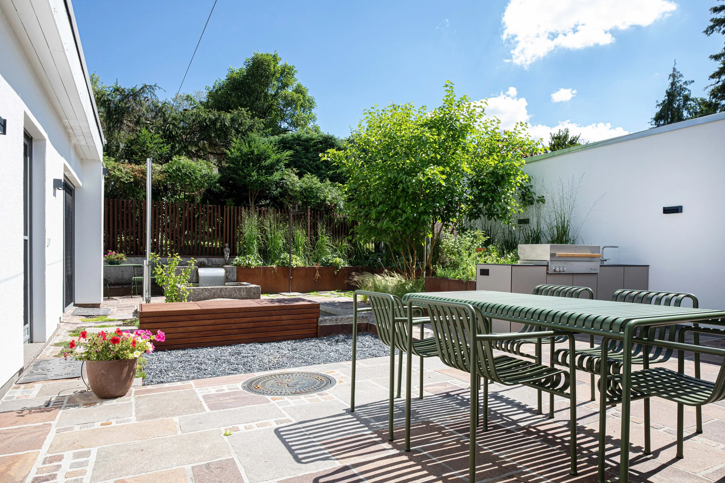 Stadtgarten mit Koibecken und Outdoorküche – Funktionalität trifft auf exklusives Design