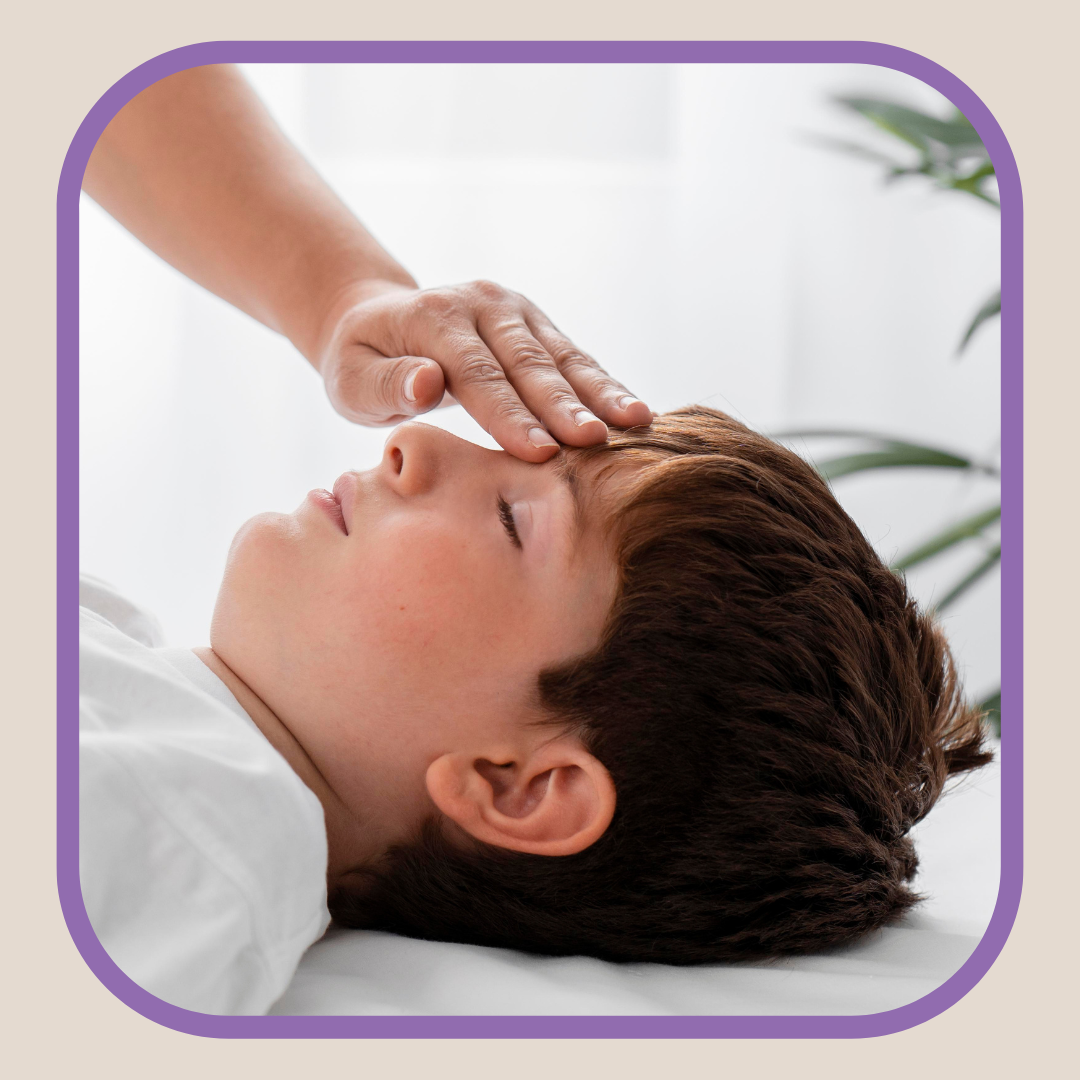 Child experiencing hands on reiki energy from practitioner.