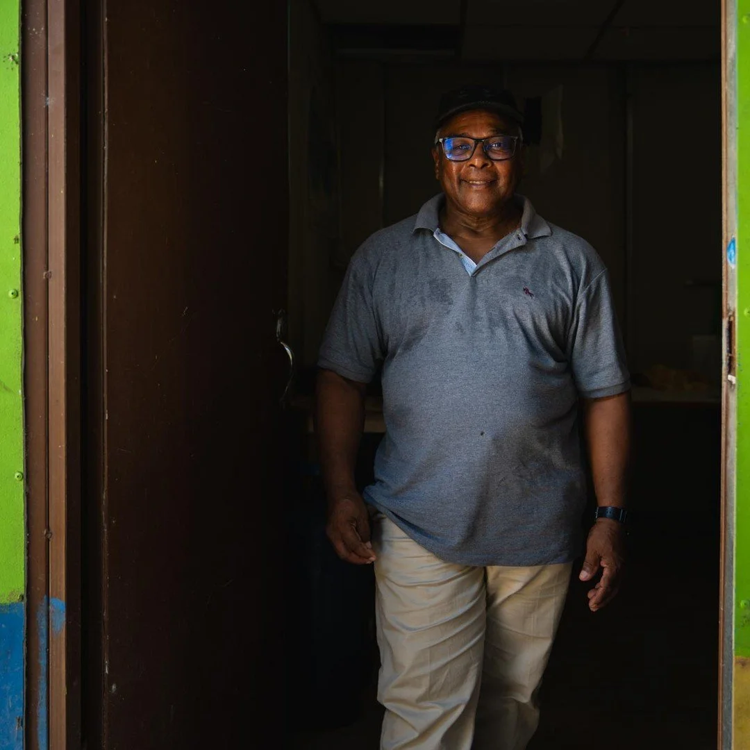 Curruco, a former FARC member living in Pondores, stands in the door to his house. He is committed to building peace starting at home and dreams of having a library full of history books to teach his seven grandchildren and two great-grandchildren th