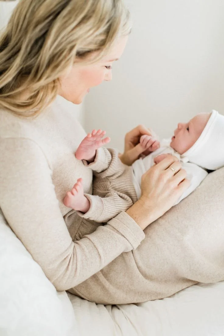 Tampa Newborn Care Specialist holding newborn baby in nursery