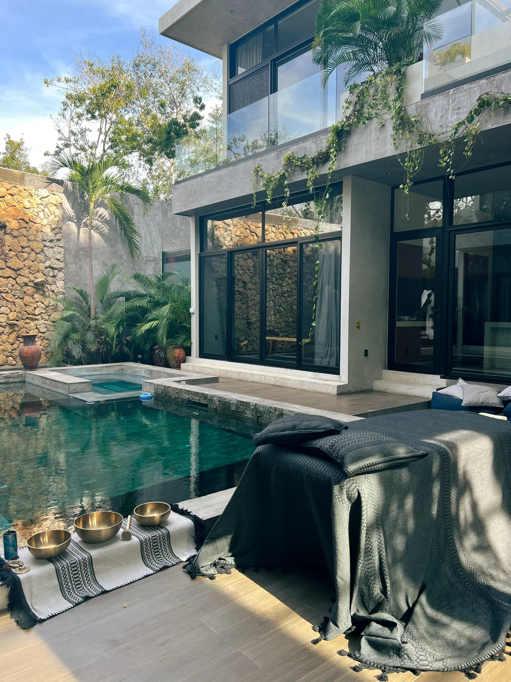 A sound healing setup beside a villa pool