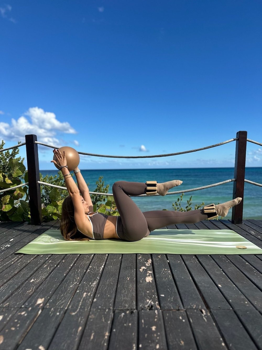 Audrey doing Pilates on a deck by the sea
