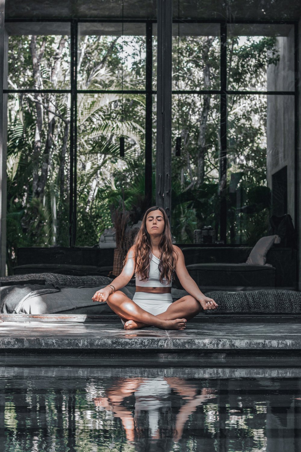 Audrey meditating in a jungle studio