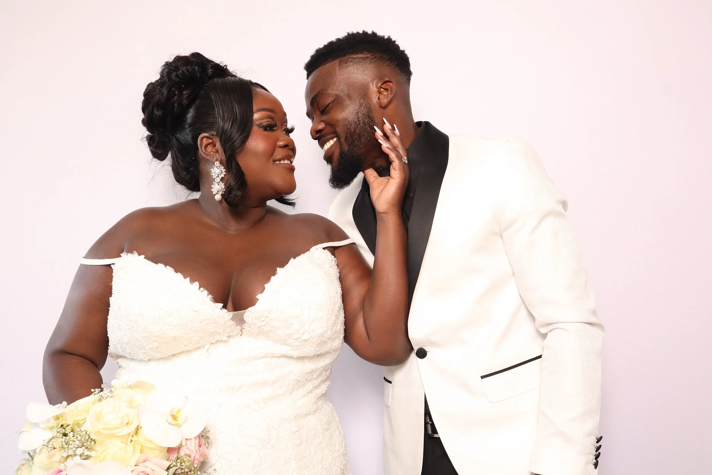 a wedding couple smiling looking lovingly into each other's eyes a beautiful couple in love and smiling posing in an atlanta photo booth