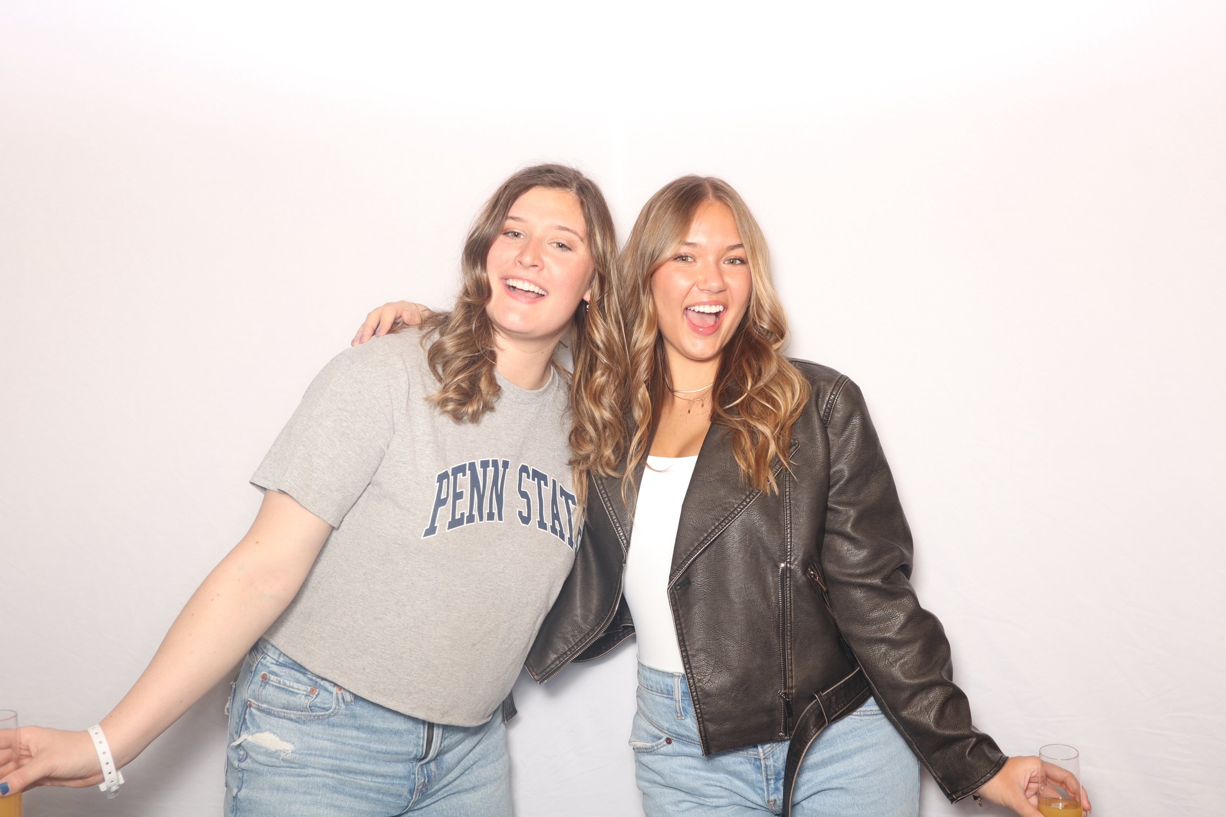 Penn State University Girls posing in photo booth in front of a white backdrop