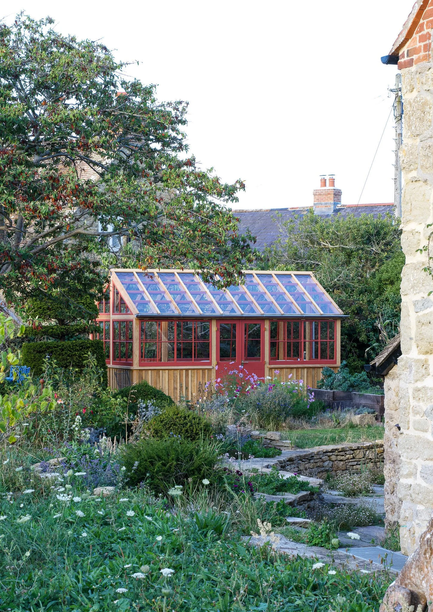 Vegetable and cut flower garden with bespoke timber potting shed, topiary, cosmos and meadow