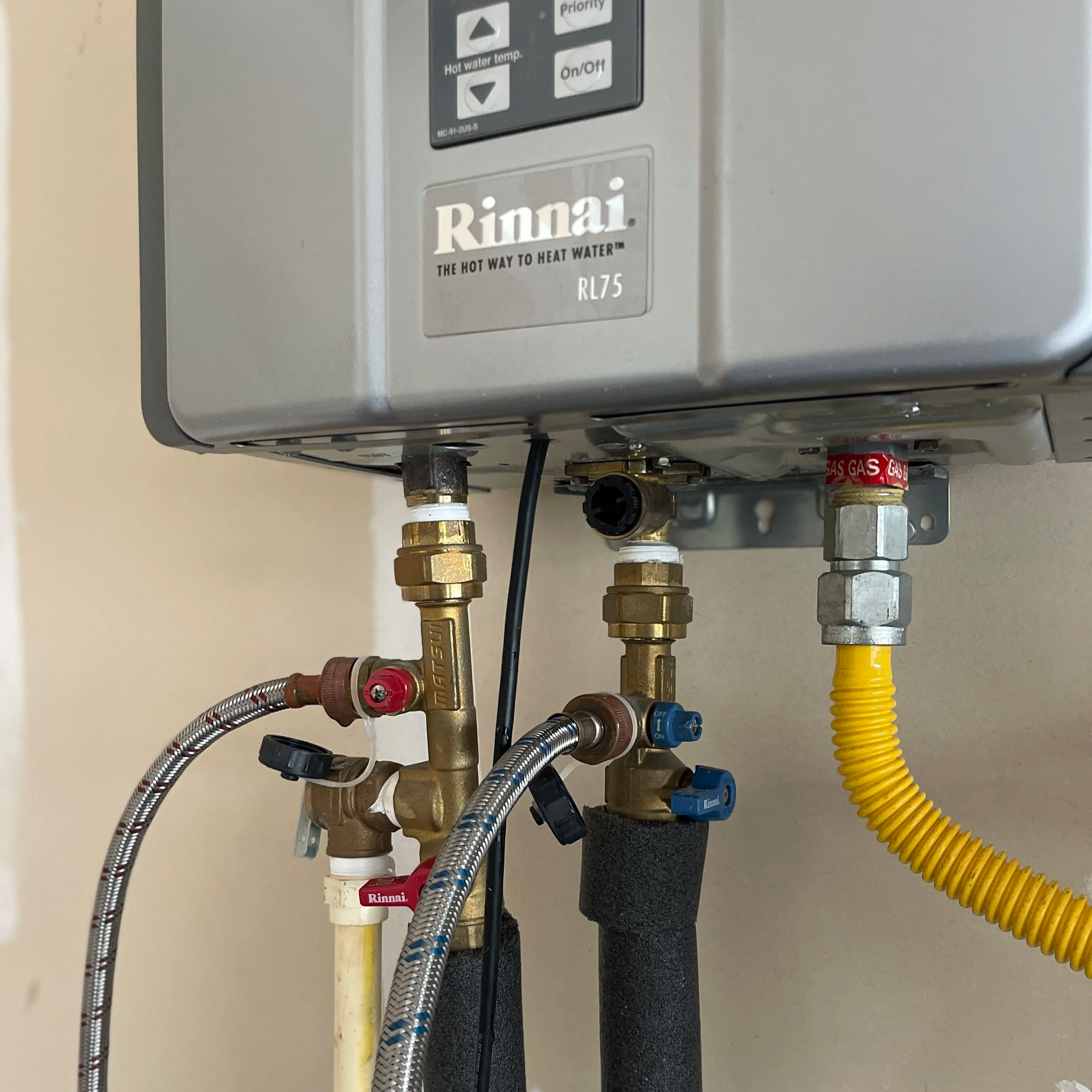 image of a Rinnai water heater in a hendersonville tn home being serviced by flow tech tankless