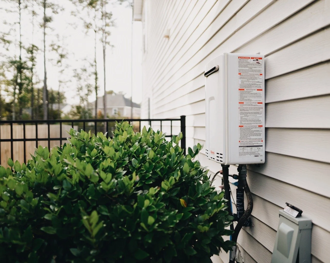 “Outdoor Rinnai tankless water heater installed on a Mt. Juliet home, showing typical setup for annual descaling and flushing.”