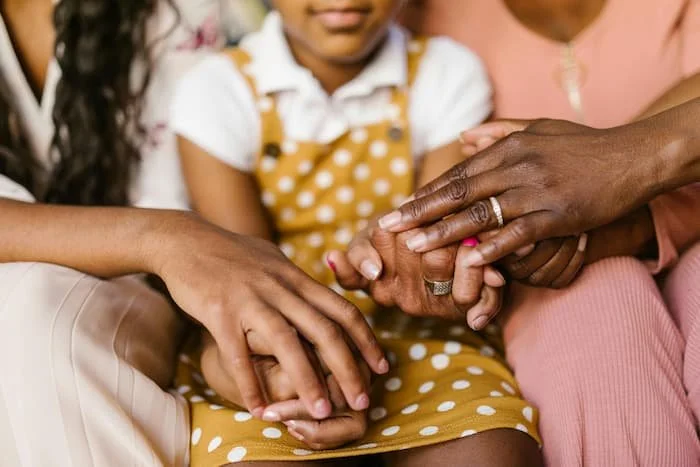 family holding hands with support