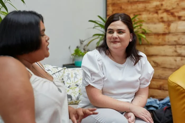 two people talking, in a therapy session, diverse ethnicities and gender identities