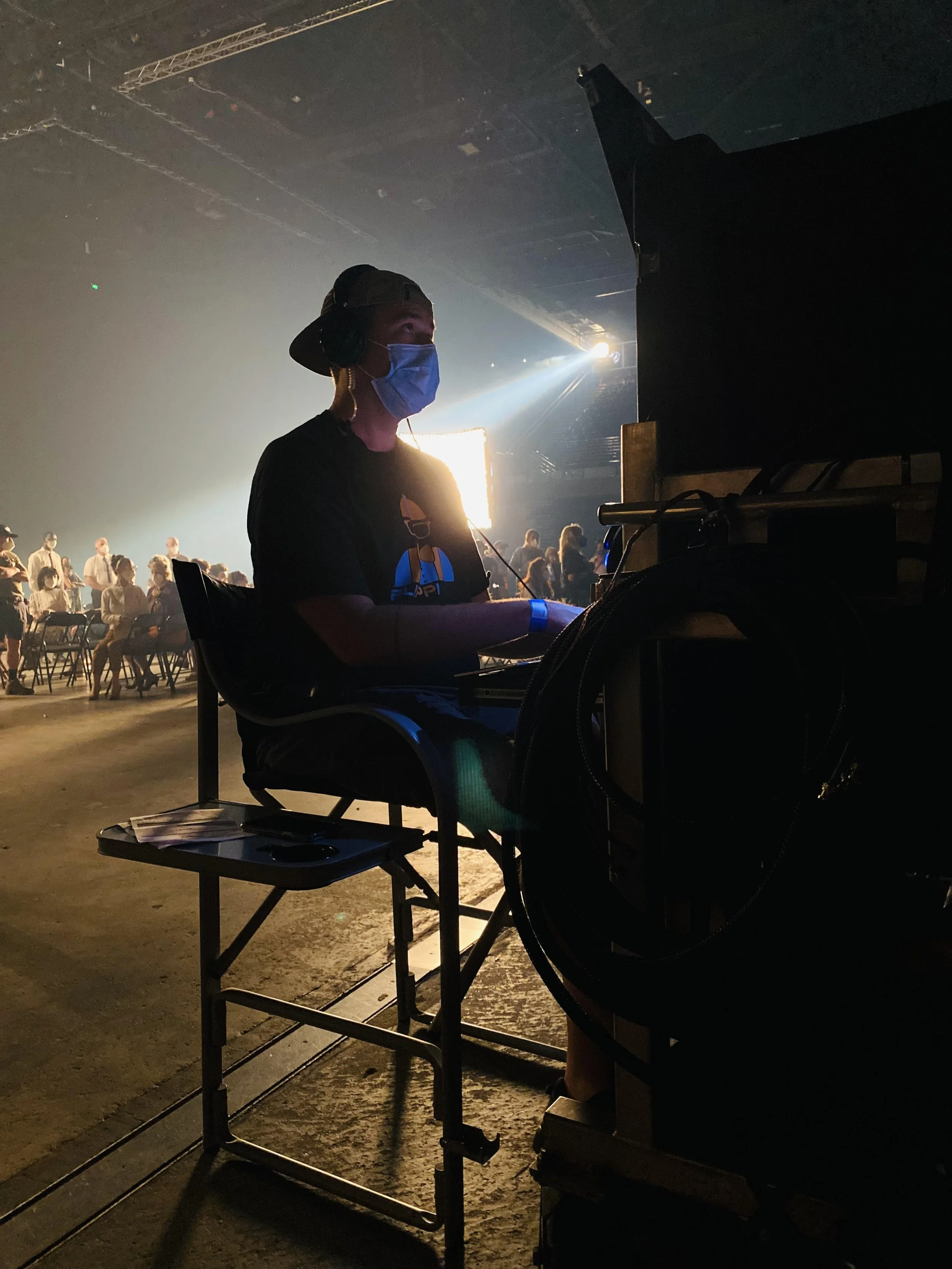 Production sound mixer operating audio equipment on a film set
