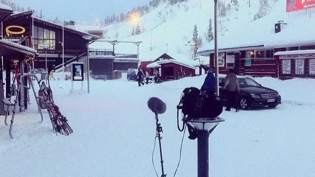Boom pole and microphone set up on a snowy outdoor film location