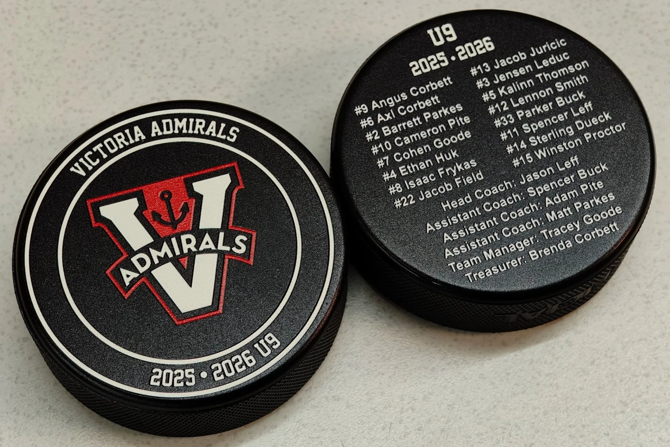 Double sided UV printed hockey puck with player names listed 