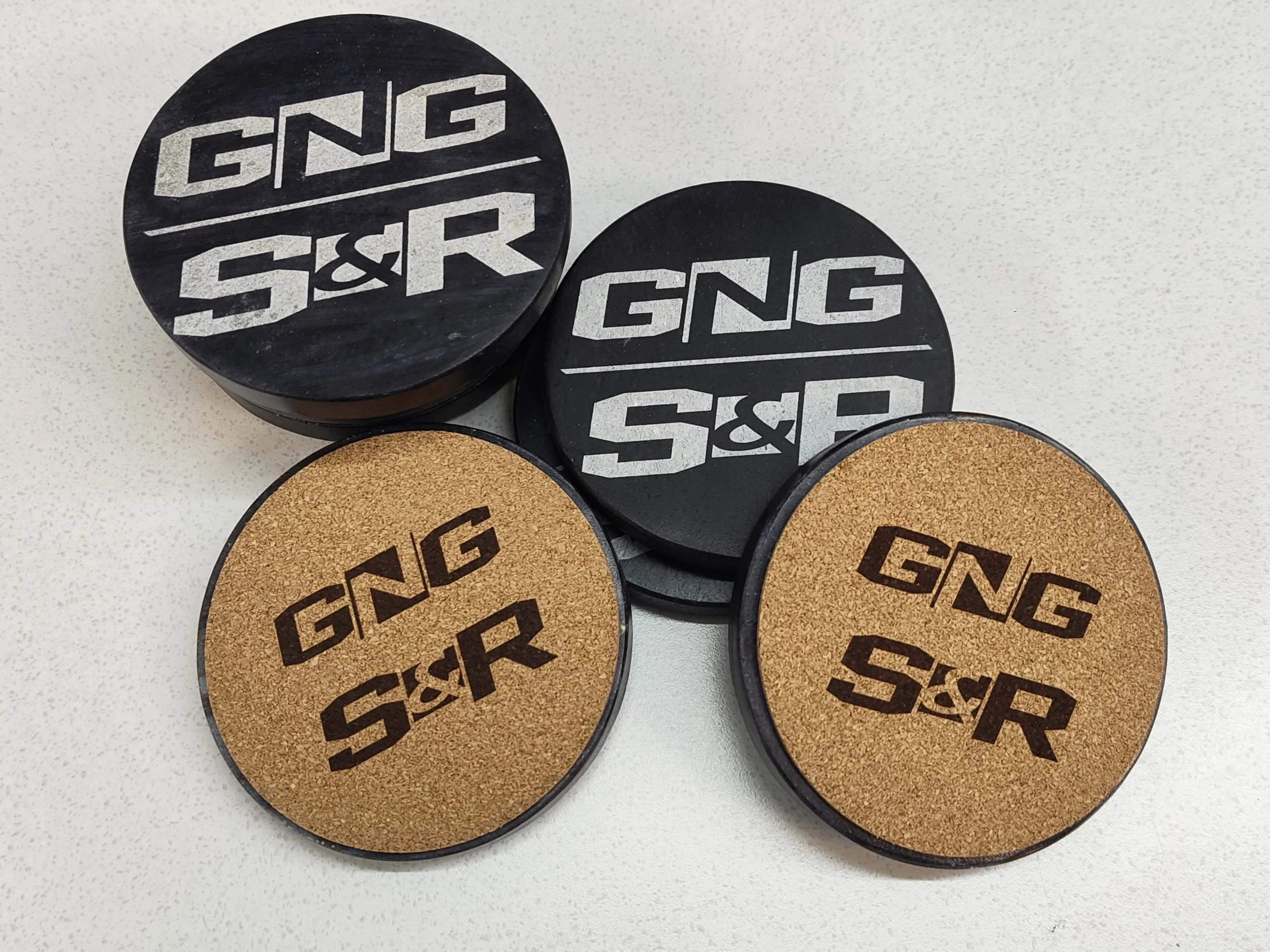 Dark marble coasters with laser engraved logo and cork backing