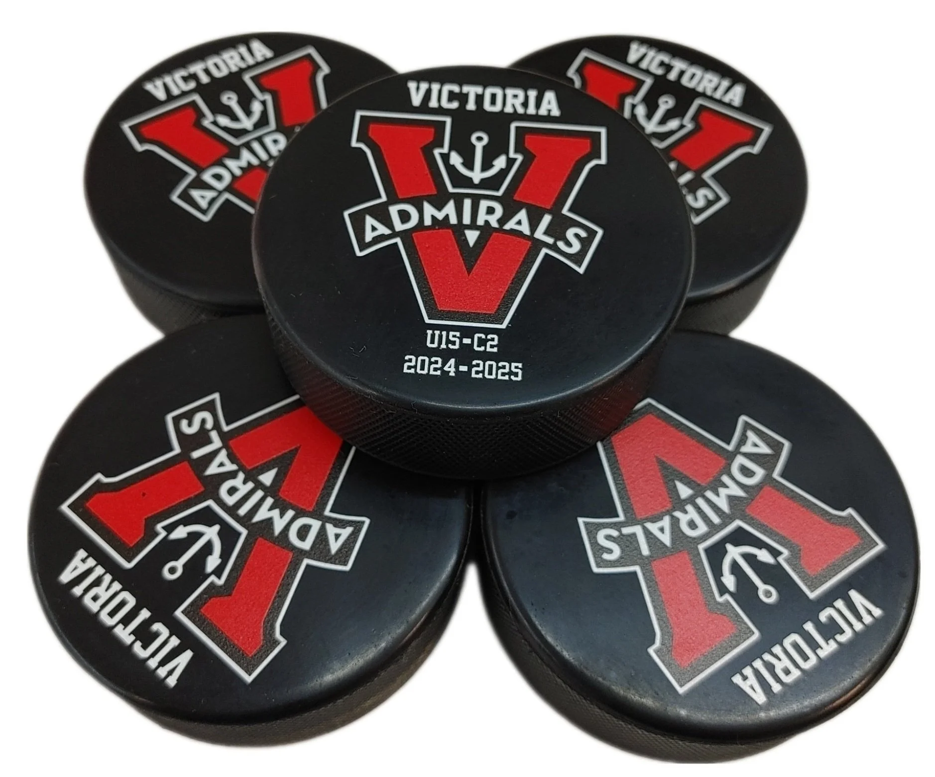 UV printed hockey pucks with a red and white Victoria Admirals logo, consisting of a large red letter V with an anchor and the words Victoria Admirals, and text indicating season 2024-2025.