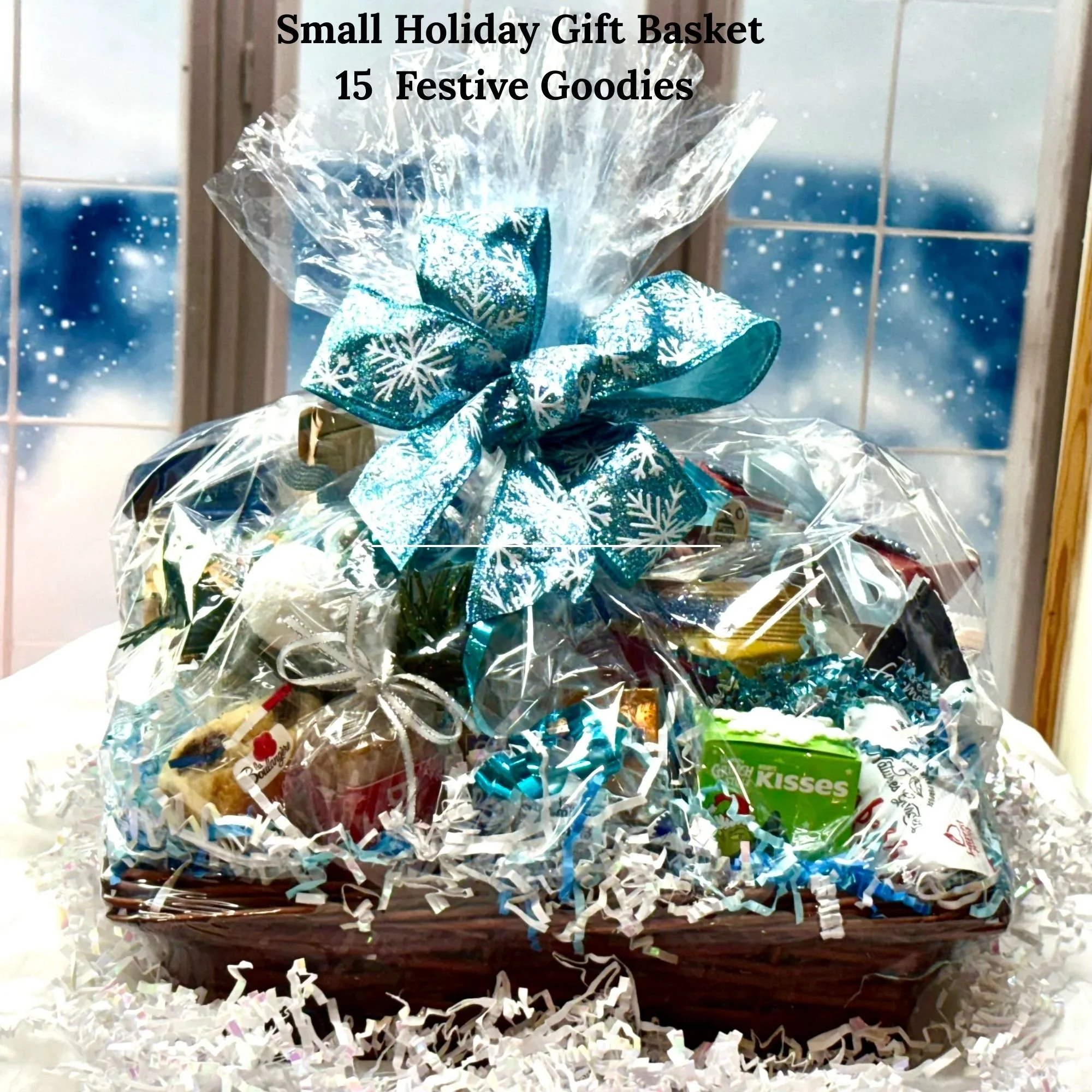 Small holiday gift basket with 15 full-size treats, wrapped in clear cellophane and finished with a blue snowflake bow.
