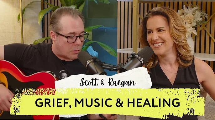 A man in a black t-shirt plays a red guitar while a woman in a blank tank top behind a microphone listens. Text reads: Scott & Raegan. Grief, Music & Healing