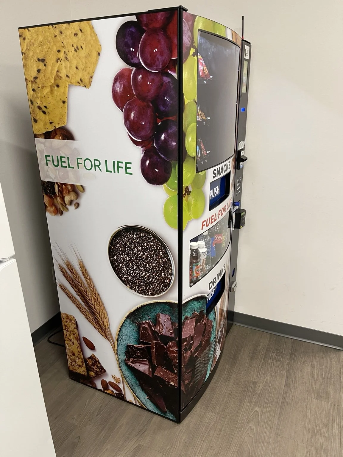 Snack and drink vending machine placed in a local workplace breakroom setting.