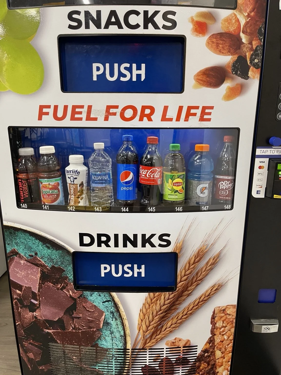 Vending machine drink selection with water, juice, soda, sports drinks, and card payment options.